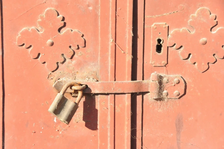 a padlock attached to a red door with a key