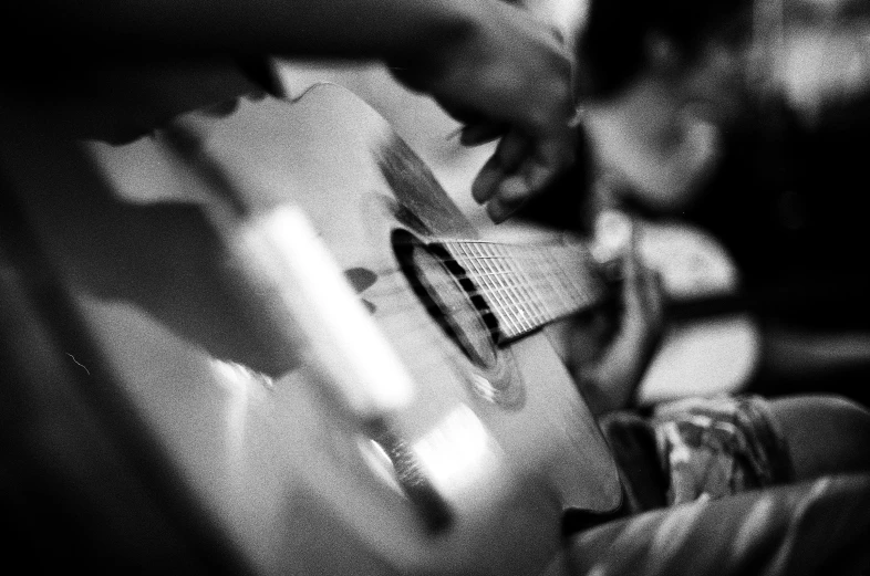 a person that is playing a guitar in a room