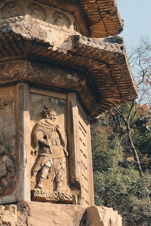 a carving of a man riding a horse next to a tree