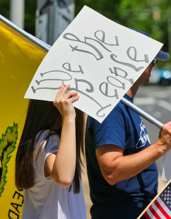 a group of people protesting with signs and flags