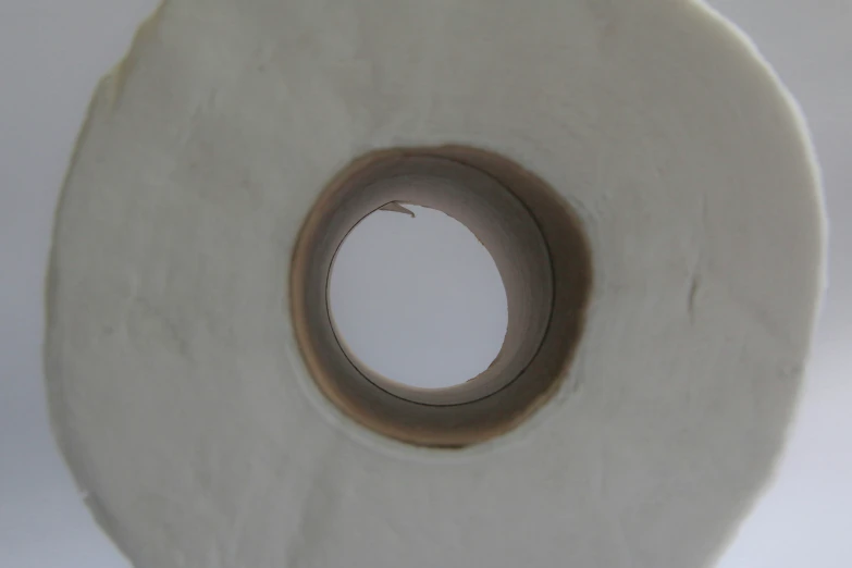 a roll of toilet paper with one hole in it