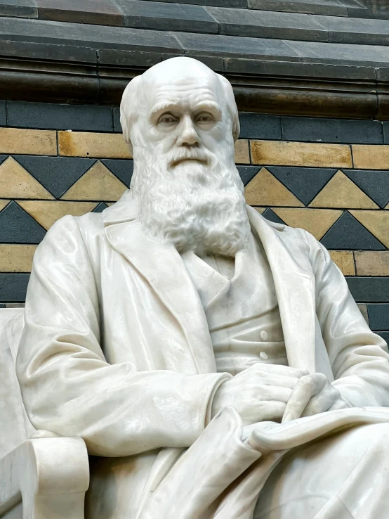 a statue of a person in white is next to a building