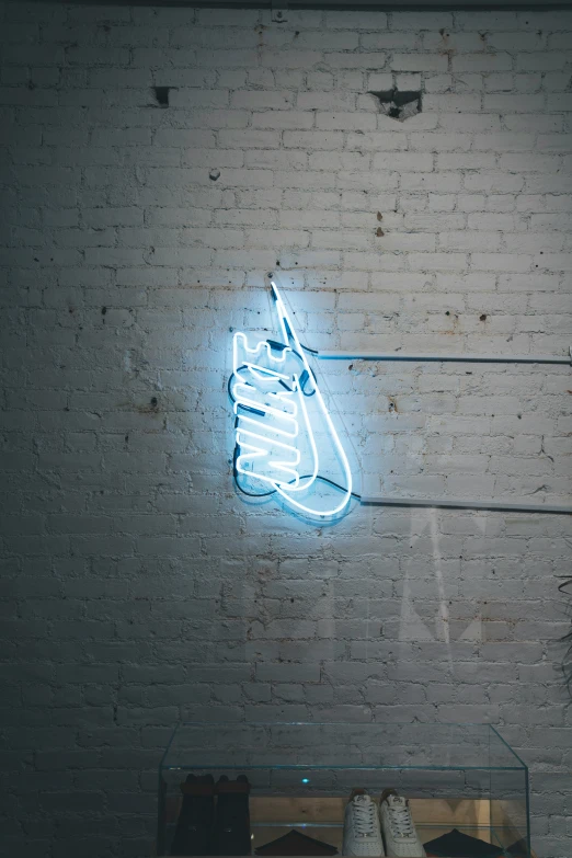 a neon sign that has a nike shoe on it