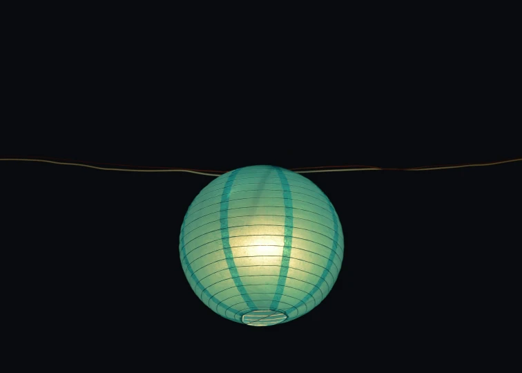 a blue lantern lit up at night in the dark