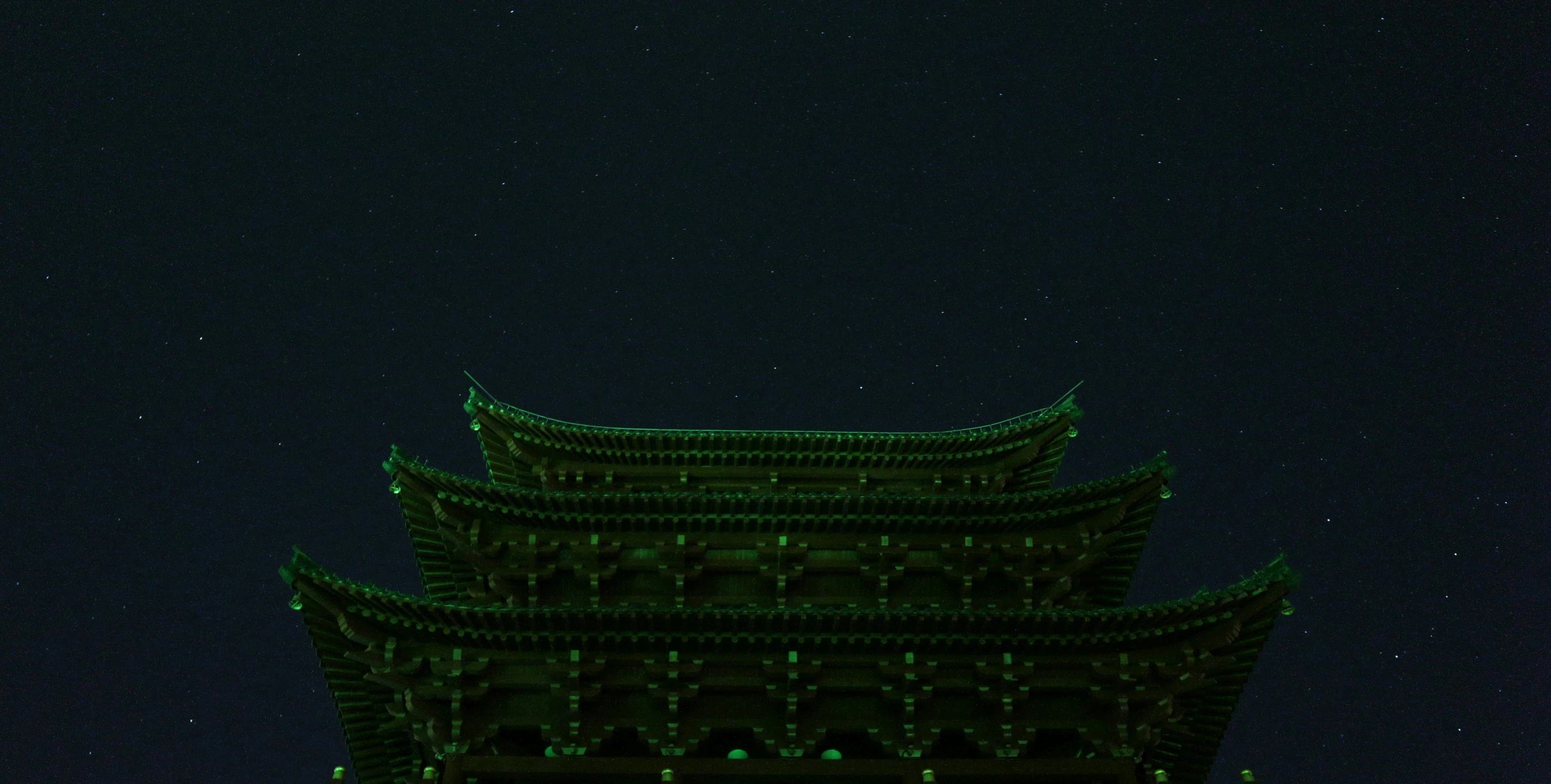 a tall tower covered in bright lights at night