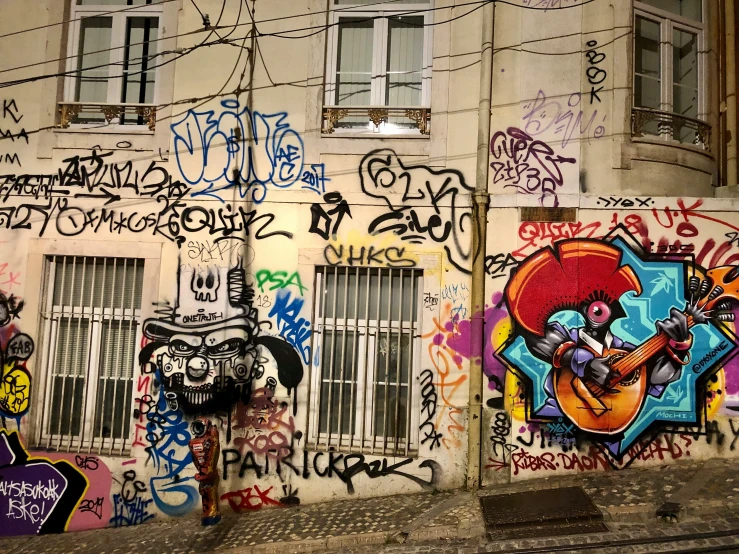 a building is covered with graffiti and has windows