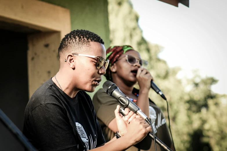 two men that are standing in front of a microphone