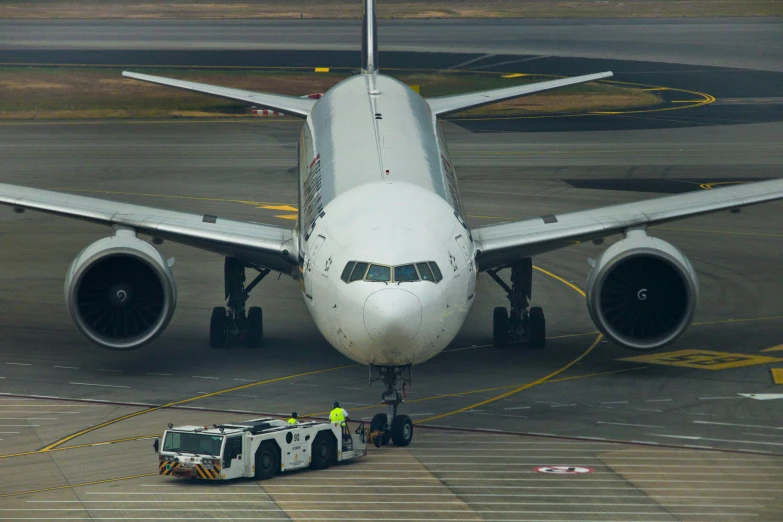 an airplane parked on the runway with its lift up to it's wheels