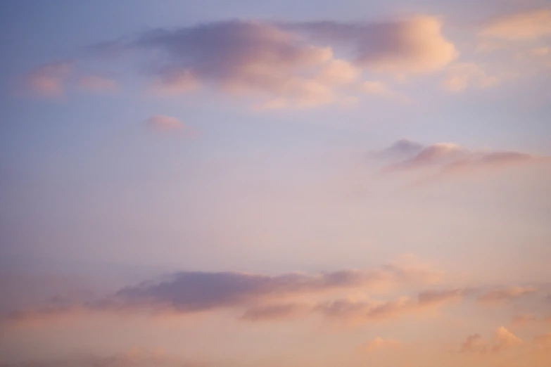 a plane is flying through the sky in an overcast