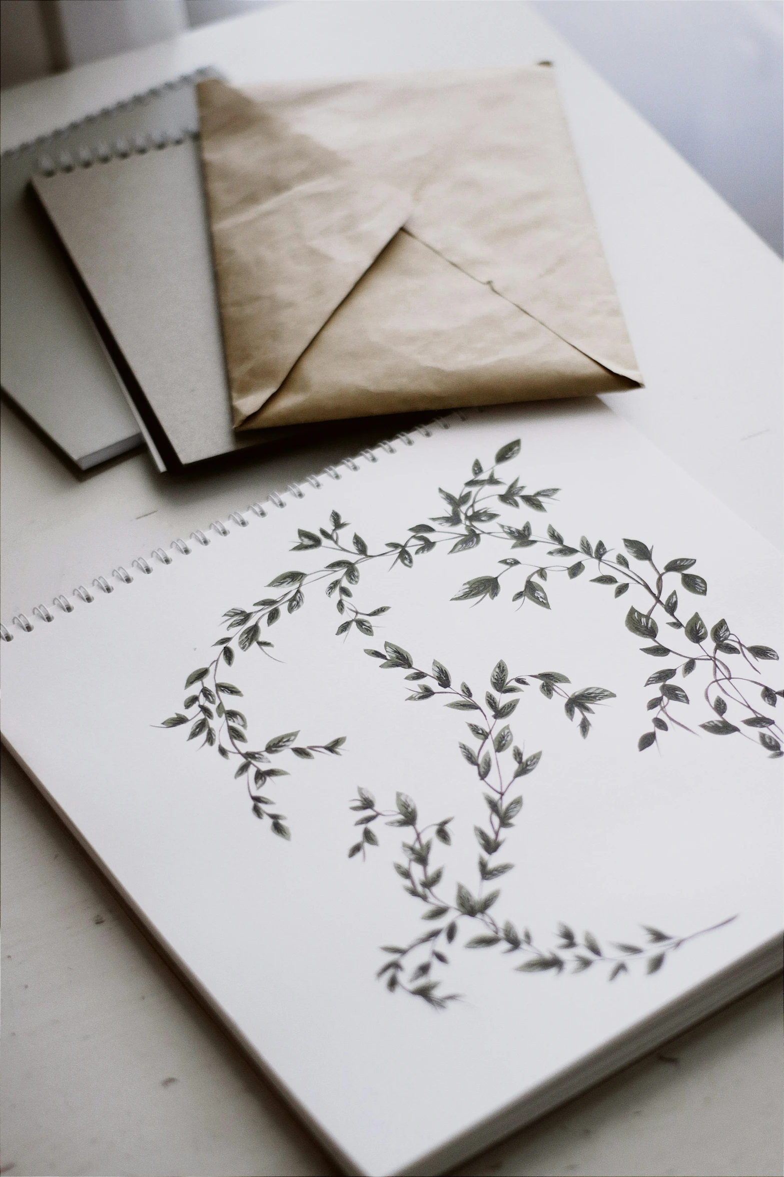 paper, envelope and envelope sitting on top of a table