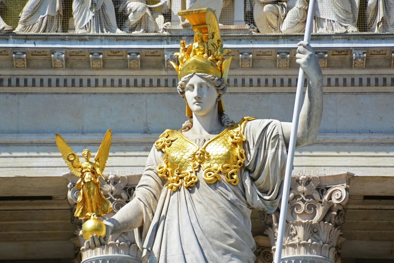 an old statue stands with a bird next to them