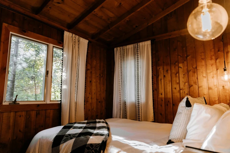 a large bed in a room next to wooden walls