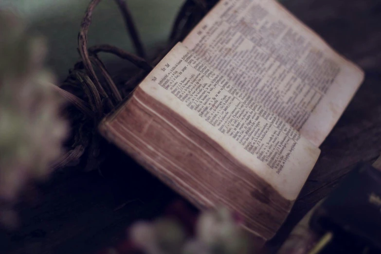 an old book with a wooden lid is sitting on a table