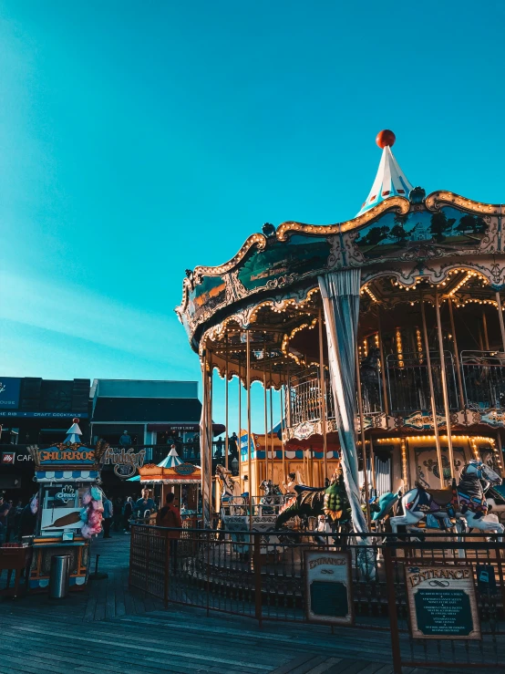 an old fashioned carousel with people on top