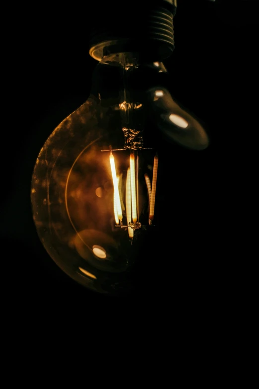 a dark lit bulb is shining in the dark