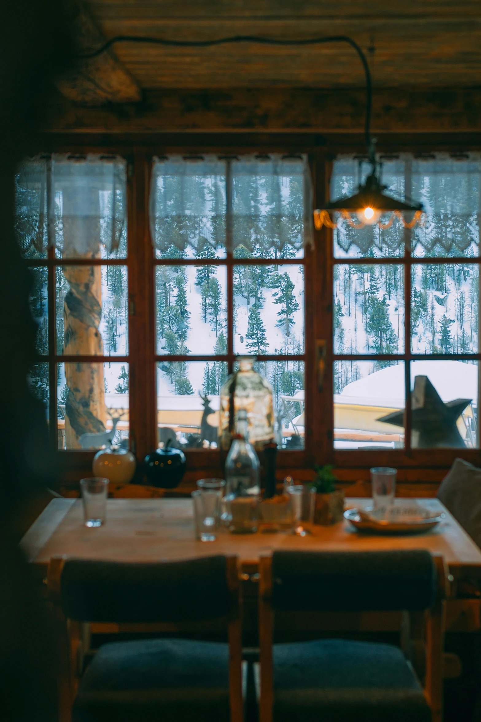 a room with many windows and a table in front of the window