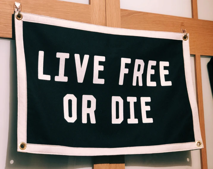 a handmade sign that reads live free or die