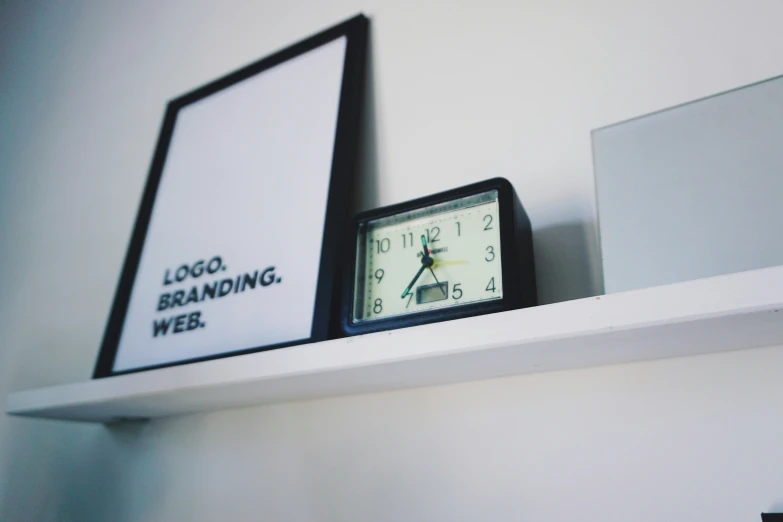 a clock with the slogan nding wei sitting on a shelf