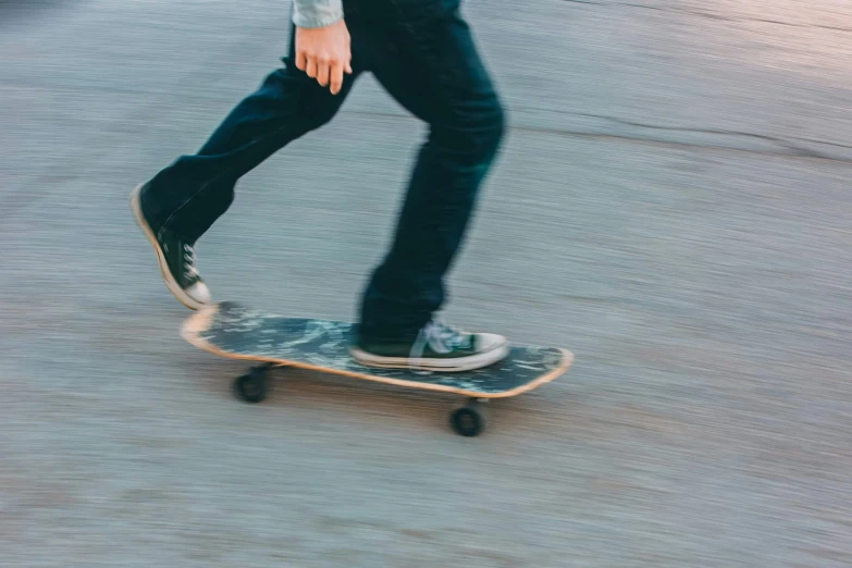 a skateboarder riding down a road in the sun