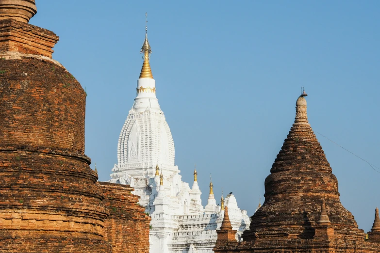 the tall temples have yellow spires next to them