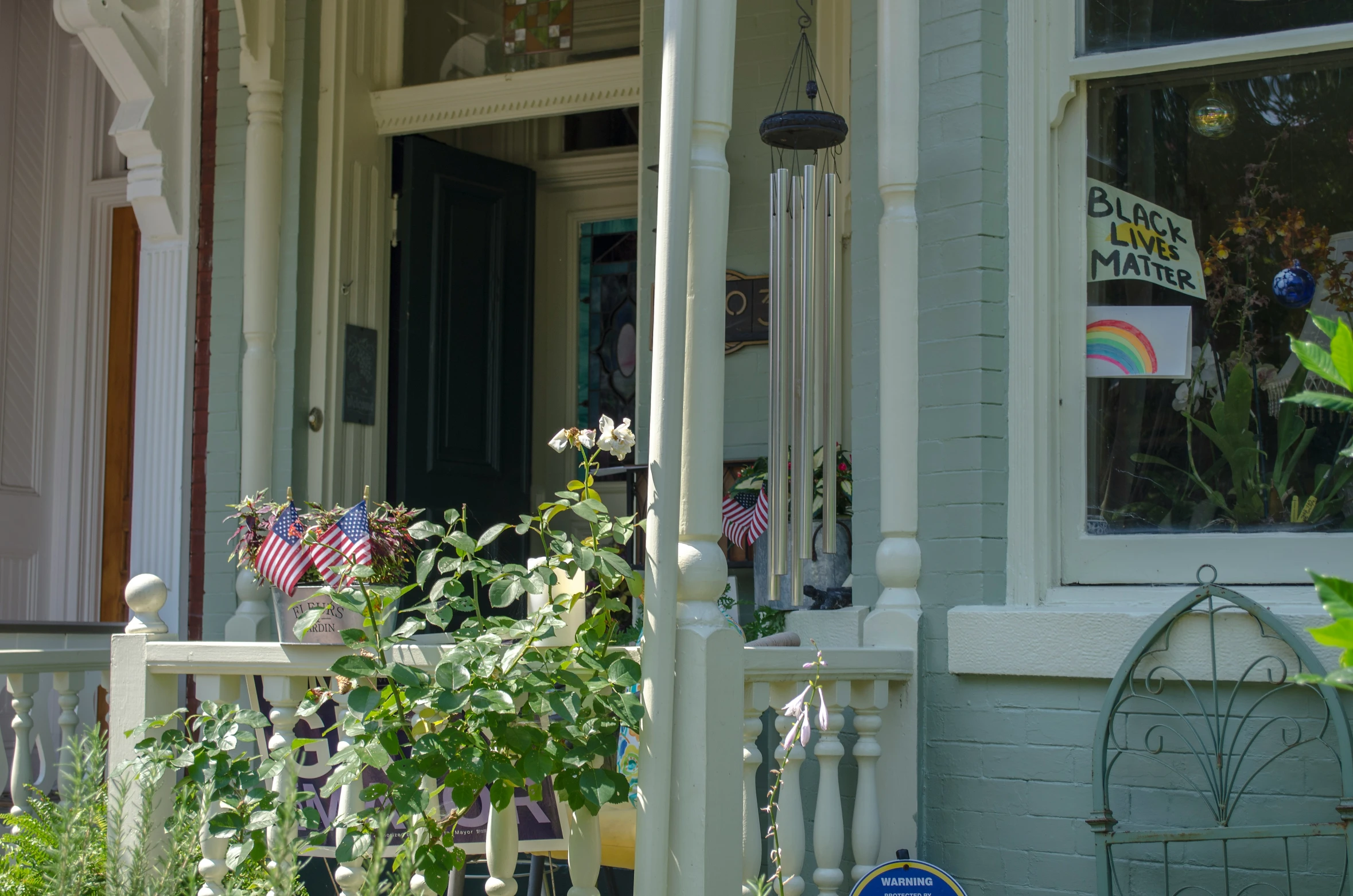 a house with flowers that are in the front porch