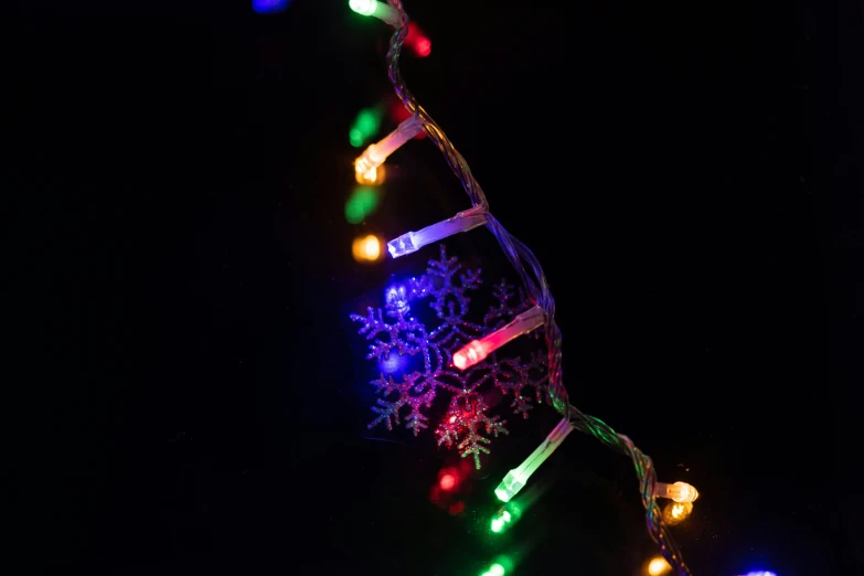 a lighted decorative item hanging in the night