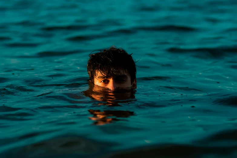 the young man is swimming alone in the ocean