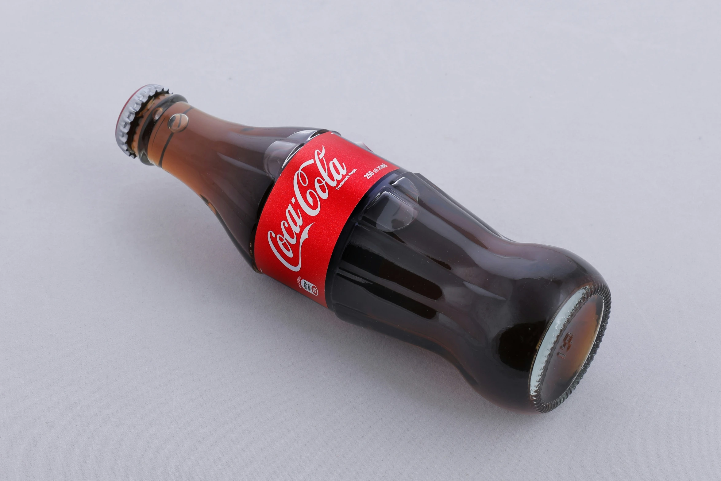 a close up view of an open cola bottle