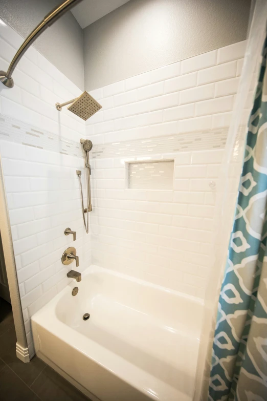 a white shower with a chrome strainer attachment