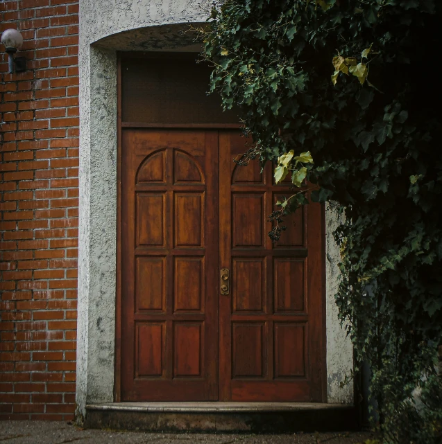 a large wooden door with a glass top window