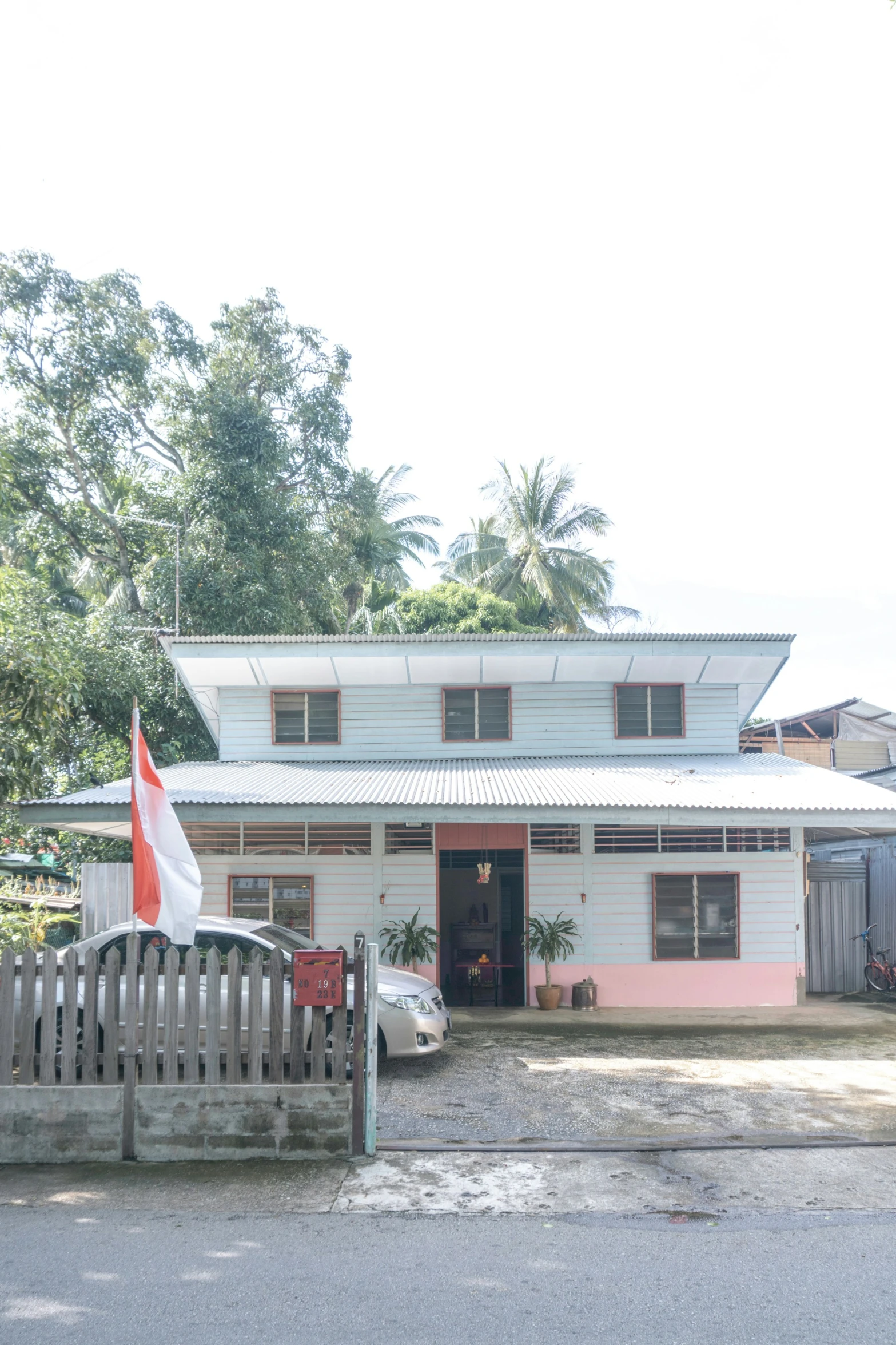 a pink house with an red and white flag on the front