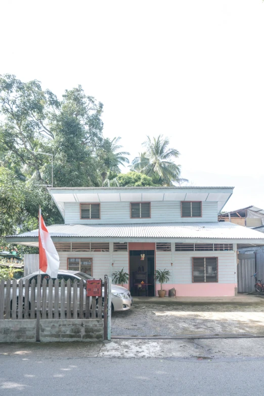 a pink house with an red and white flag on the front