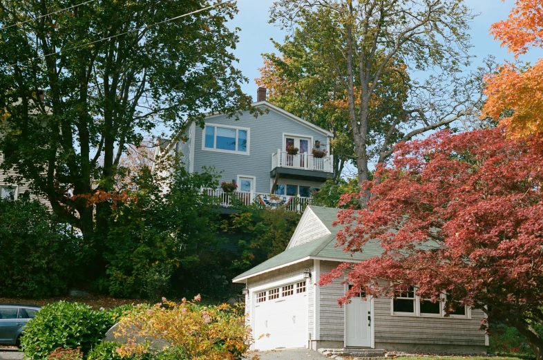 a building sitting next to trees and a road