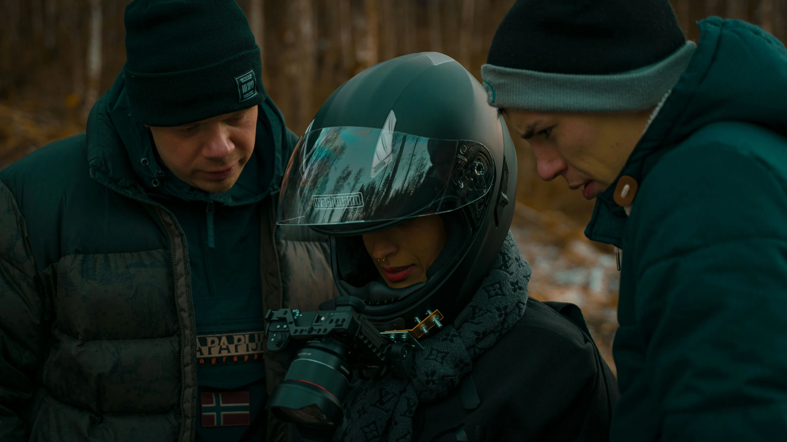 a man standing next to a woman wearing a helmet