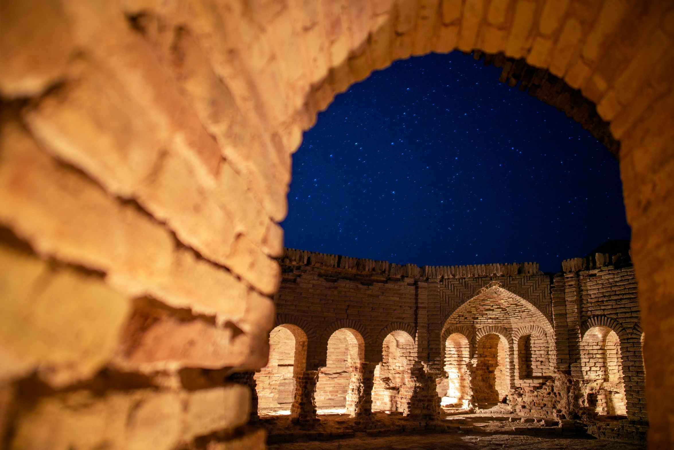 a small arched window is opening into the night sky