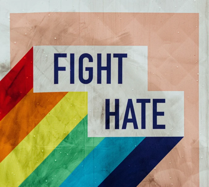 the colors of rainbow with the word fight hate in white writing