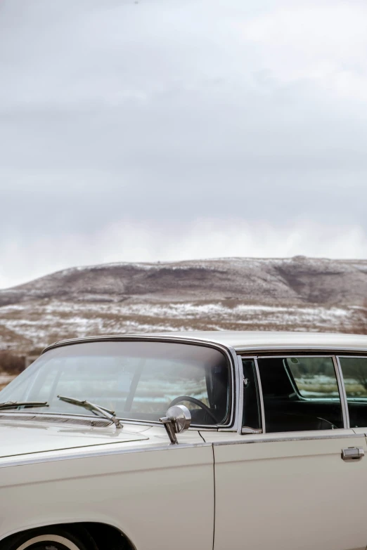 a car parked on the road in front of a mountain