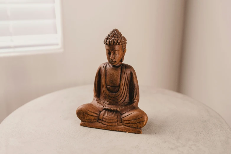 buddha statue sitting in the corner of a room