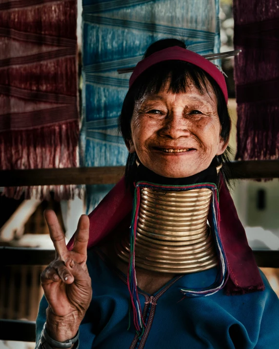 a woman with a collar ring holding a peace sign