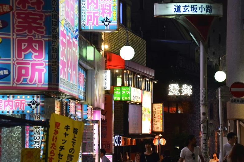 some people on a street some signs lights and buildings