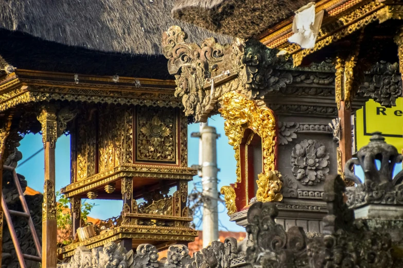 many elaborate carvings and pillars of wood in a hut