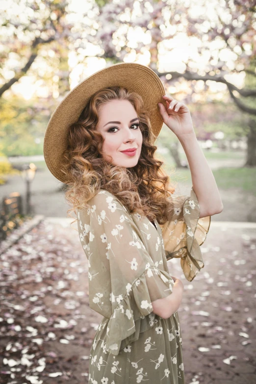 a beautiful woman is standing with her hat on