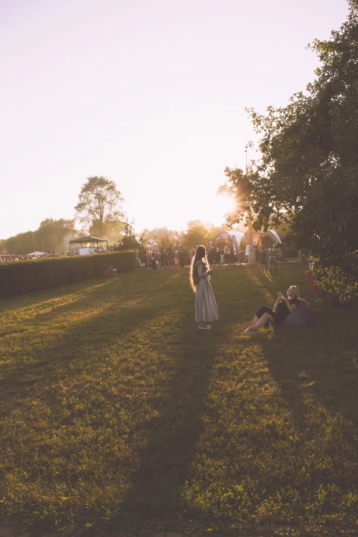 some people are walking in the grass on a sunny day