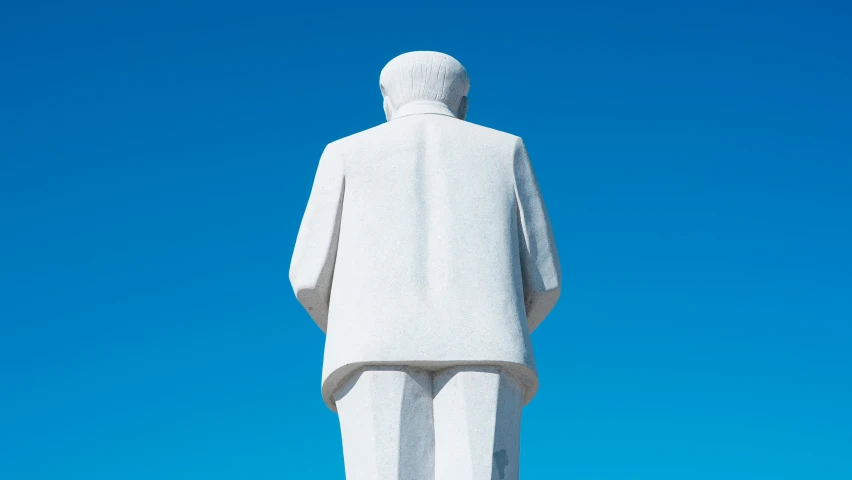 the rear view of a statue, with a clear blue sky behind it