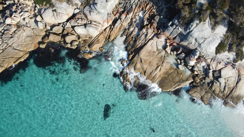 aerial view of rocky beach, rock formation and water