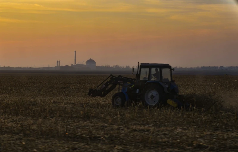 there is a tractor and a plow in a field