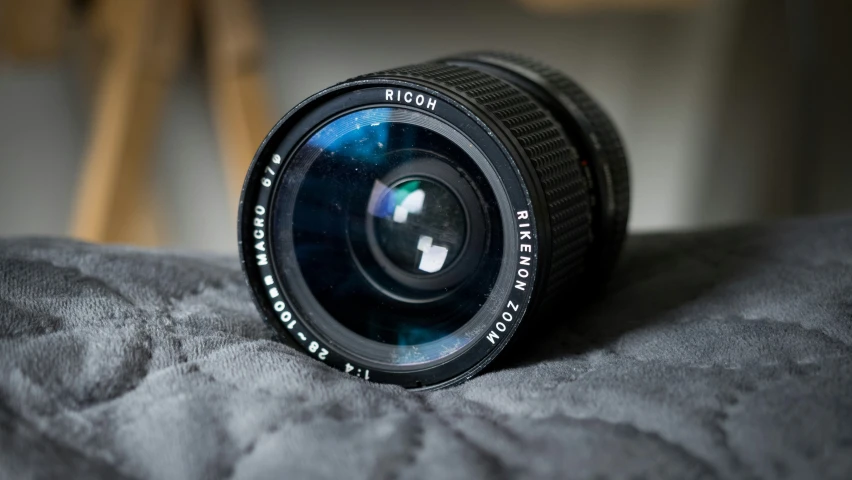 closeup of a camera lens showing the reflection