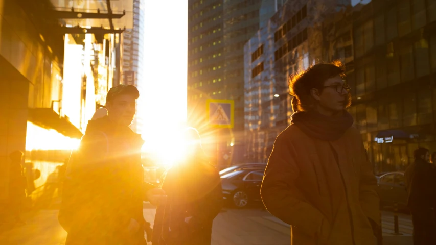 two people walking next to each other on a sidewalk