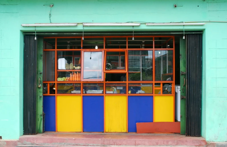 an orange, yellow and blue window of an apartment building