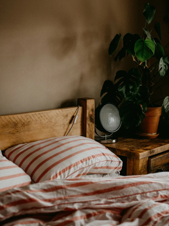 an old bed with two red and white  pillows